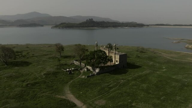 Aerial view of small Mosque on the shore of Khanpur Dam close to Islamabad, Pakistan capital