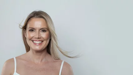 Wanddecoratie Schoonheidssalon Nice cheerful healthy blonde mid adult mature woman looking at camera on white background. Mature lady portrait. Healthy face, skin care beauty, middle age skincare cosmetic and cosmetology concept  © artmim