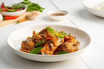 Stir Fry Thai Basil with Canned sardine fish in white plate.Thai food.quick dish menu.