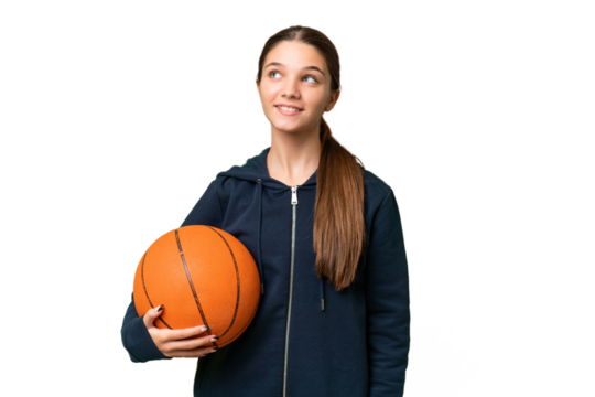 Teenager caucasian girl playing basketball over isolated background thinking an idea while looking up
