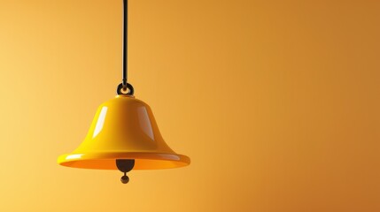 Obraz premium Bright Yellow Bell Hanging Against a Warm Orange Background