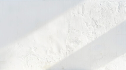Texture image of a white wall with sunlight creating diagonal shadows.