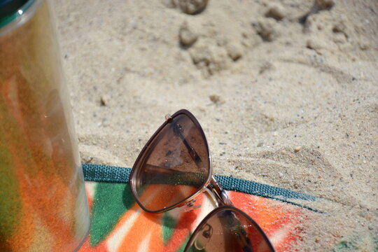 sunglasses on beach towel on vacation day
