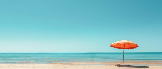 A beach scene with an orange umbrella on the sand