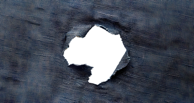 Hole in black fabric with frayed edges, cut out