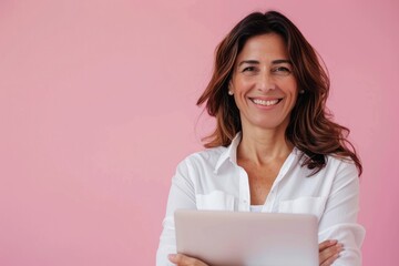 Middle Age Woman Laptop. Beautiful Hispanic Senior Business Woman Working on Laptop Over Pink Background