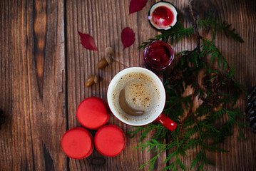 Autumn, fall leaves, hot steaming cup of coffee and a warm scarf on wooden table background. Seasonal, morning coffee, Sunday relaxing and still life concept.