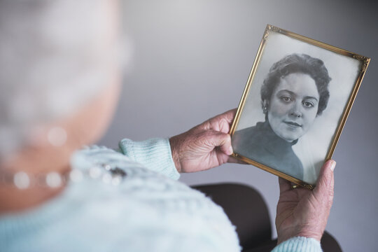 Senior woman, hands and photograph in nursing home for history, remember or nostalgia top view. Vintage, photography and elderly person in retirement house with picture, memory or past reflection