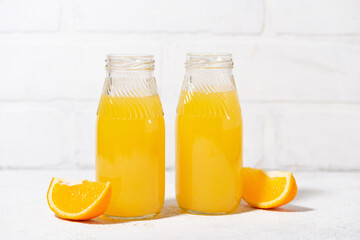 freshly squeezed orange juice in glass bottles, closeup