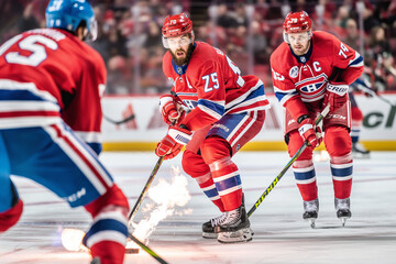 Hockey players in high-tech gear battle for the puck amidst a sea of red, white, and blue versus red, yellow, and black. Fans erupt in cheers, augmented by cutting-edge AR displays.