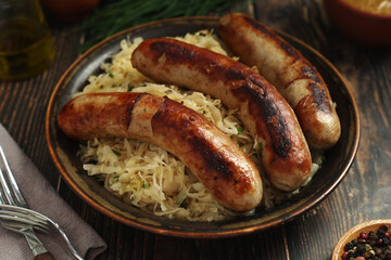 A bowl with Bratwurst and Sauerkraut as side dish - traditional German food