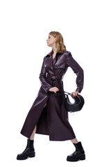 Fototapeta premium High fashion photo of a beautiful elegant young woman in pretty long purple lilac leather jacket, coat, handbag posing on white background. Slim figure. Blonde