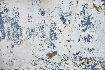 A wall with a lot of holes and cracks