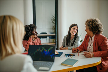 Shot of a group of businesspeople sitting together in a meeting