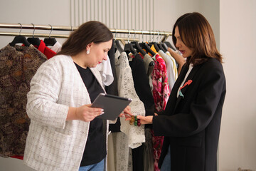 bloggers are engrossed in a conversation about their content, using a tablet and fashion magazine for their brainstorming session. This image showcases the collaborative and strategic aspects of