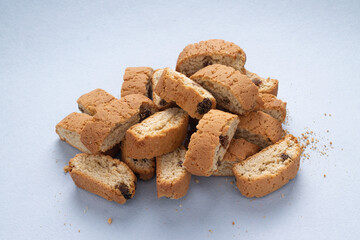 Italian cantucci cookies, on a blue background, side view