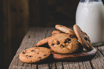 Oatmeal, chocolate chip and milk cookies on wooden background