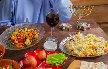 The table is festively set with matzo and kearah for the Jewish holiday of Pesach Seder