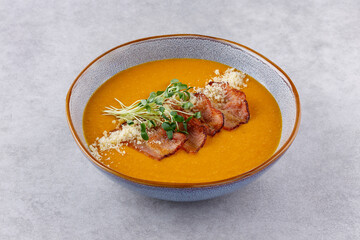 Red lentil soup puree on stone table. Top view.