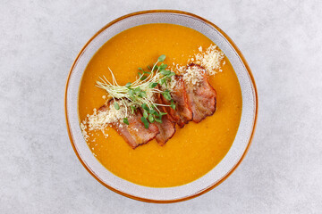 Red lentil soup puree on stone table. Top view.