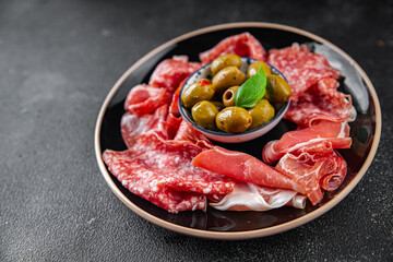 meat plate different types of meat salami, prosciutto, sausage, coppa natural food fresh appetizer meal food snack on the table copy space food background rustic top view