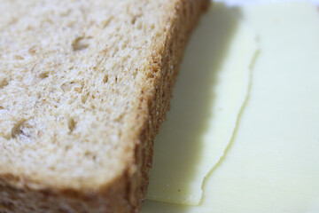 slice of bread. bread and cheese. Details of the piece of bread with cheese. Bread and cheese texture.