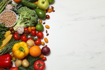 Source of protein for vegetarians. Different fresh vegetables, fruits and herbs on white marble...