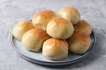 Delicious dough balls on grey table, closeup