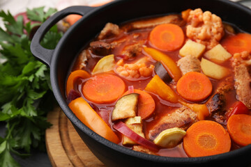 Tasty homemade stew with vegetables on table, closeup