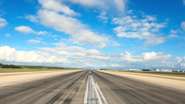 Camera goes through the middle of the airport runway. The white lines show the centerline. And the skid marks of the aircraft tires