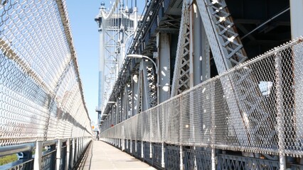 Fototapeta premium Manhattan Bridge to Brooklyn Dumbo. New York City symbol, USA travel destination. Architecture of United States, tourist landmark. Cable-stayed bridge. Pedestrian path perspective.