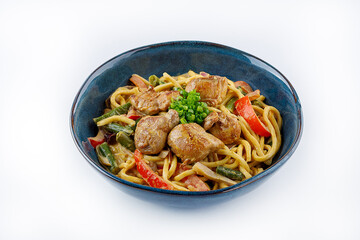 Egg noodles with curry sauce and chicken on a white background