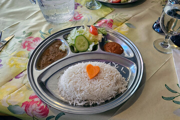 Meal with rice, salad and gravy served with heart shaped carrot