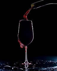 red wine pouring into glass