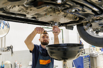 old car oil drained from the engine for a new oil change at a service center or oil change shop