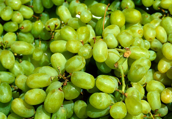 Close up view of a box of ripe green grapes on a market stall
