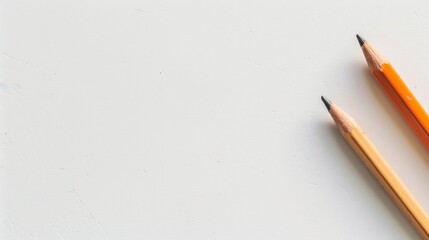 Two Yellow Pencils on a White Surface