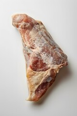 Raw chicken thigh with salt on white background