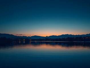 Fototapeta premium Tranquil Lake Sunset with Mountain Silhouettes