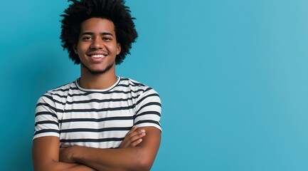 Fototapeta premium Young Man with Afro Smiling in Striped T-Shirt Against Blue Background