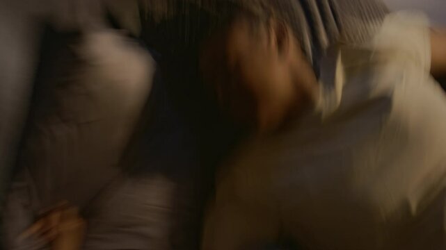 Top view of young Black female war veteran with sleep disorder having nightmares of catastrophic past events at night. Life with post-traumatic stress disorder