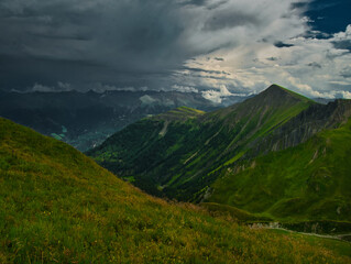 Obraz premium View on a storm cloud and mountains near ski resort Serfaus Fiss Ladis on a summer day