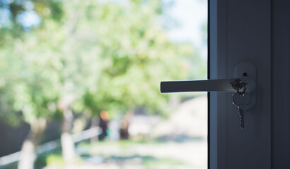 A fragment of a new plastic door with a handle in a private house