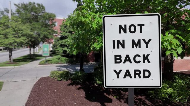 A hypothetical "Not In My Backyard" (NIMBY) sign in a typical American small town.  	