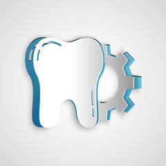 Paper cut Tooth treatment procedure icon isolated on grey background. Tooth repair with gear. Paper art style. Vector