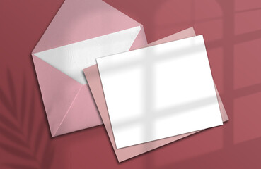 Logo paper template. A square paper mockup in realistic shades with an envelope on a pink background. Tropical shade plants. Template, flyer, poster, blank ad, special invitation
