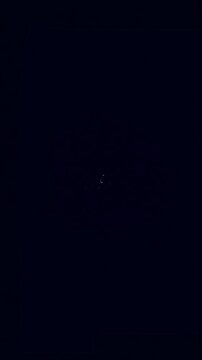 Gathering of black spheres to the center light animation. Attraction of objects. 3D abstract concept of collaboration. Magnetic attraction of objects to center. Vertical video