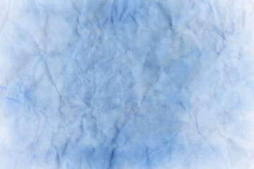 Blue wrinkled texture paper background with white faded grunge texture border 