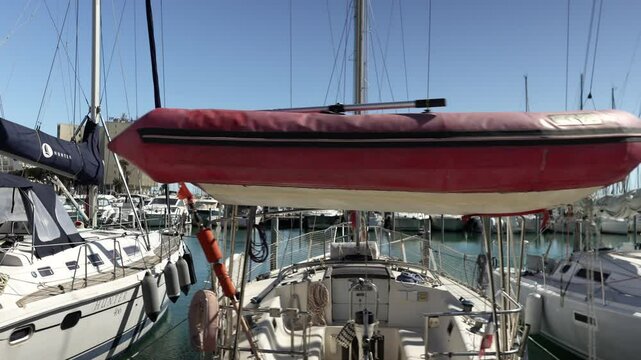 Close-up of a red-hulled sailboat deck moored in Grande Motte, France