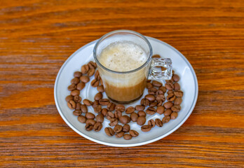Espresso coffee served in a transparent cup with roasted coffee beans. Gourmet, 100% Arabica special